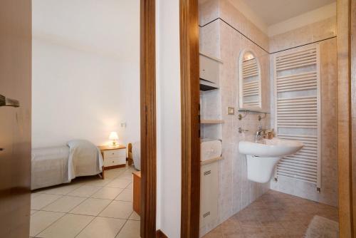 a bathroom with a sink and a toilet in a room at Stella del Garda 2 con terrazza in Tignale