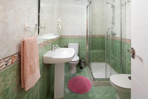 a bathroom with a sink and a shower and a toilet at Casa Santo front beach in Cala del Moral