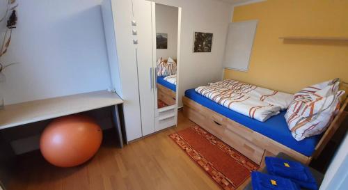 a small bedroom with a bed and a mirror at Haus im Grünen in Hoppegarten