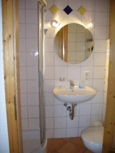 a bathroom with a sink and a mirror at Am Neuhausbauernhof in Königsfeld im Schwarzwald