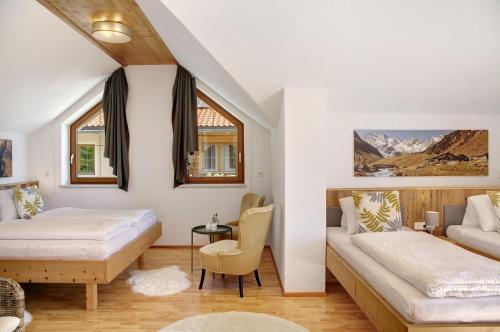a bedroom with a bed and a couch and a table at Zillertalblick in Zellberg