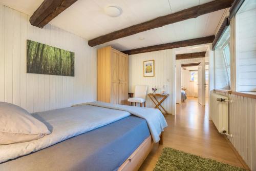 a bedroom with a bed and a table and a chair at Alte Polsterei in Nienstädt
