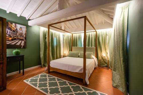 a bedroom with a canopy bed and green walls at Villa Assolata in Pietraviva