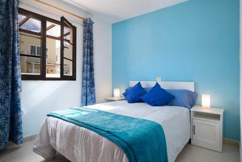 a bedroom with a large bed and a window at Casa Candido in Playa Honda