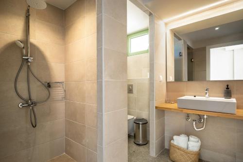 a bathroom with a sink and a shower at Joy Horizon in Skala