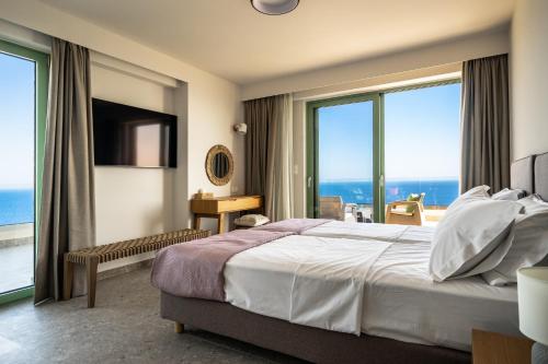 a hotel room with a bed and a large window at Joy Horizon in Skala