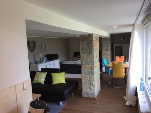 a living room with a couch and a bed in a room at Ferienhaus Dell in Möhnesee