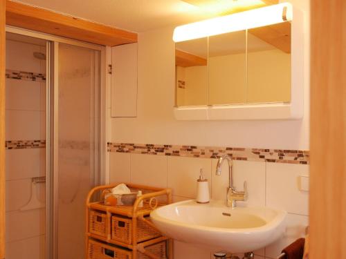 a bathroom with a sink and a mirror at Haus Trötschler in Weilheim