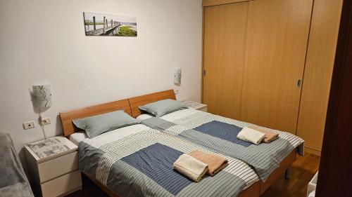 a bedroom with a bed with two towels on it at Apartment Laguna 70 in Izola