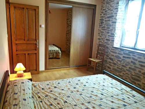 a bedroom with a bed and a large mirror at Gite Belcastel -Village d’Exception in Belcastel
