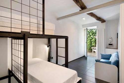 a bedroom with a bunk bed and a chair at Beroni su due livelli in Bonassola
