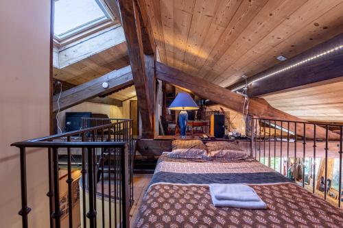 a bedroom with a bed in a room with wooden ceilings at Chalet Les Menuires Val Thorens in Praranger