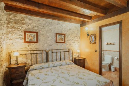 a bedroom with a bed and a bathroom at La Morada del Cura in Calabazas