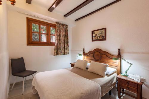 a bedroom with a bed and a chair and a window at Casa Victor - Apartment 3 in La Orotava
