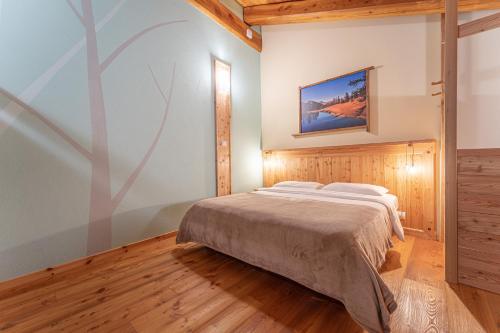 a bedroom with a bed and a painting on the wall at Civico 7 in Marmora