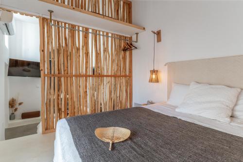 a bedroom with a large bed with a large window at Lithos in Kóstos