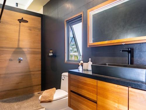 a bathroom with a sink and a toilet at Stunning Sea View Villa Olivia 3Br & Private Pool in Chaweng Noi Beach