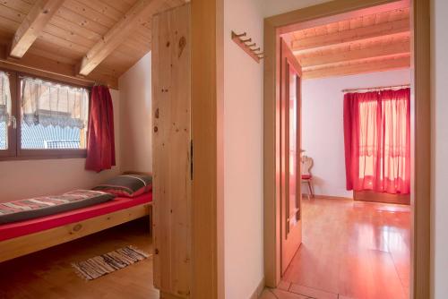 a small room with a bed and a window at Apt Bergblick Hinterproslhof in Sarntal