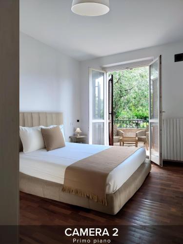 a bedroom with a large bed and a sliding glass door at Villa Gelsi a Pesaro in Pesaro