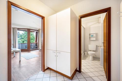 an open bathroom with a toilet and a mirror at Apartement Bublitz in Travemünde