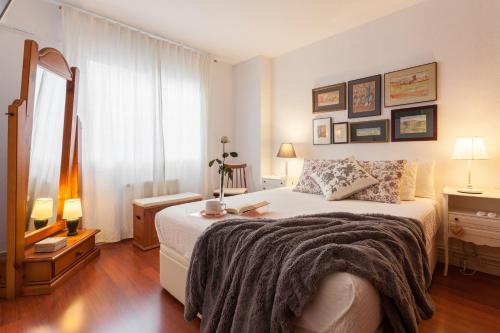 a bedroom with a large bed and a window at Canet Platja Apartment in Canet de Mar