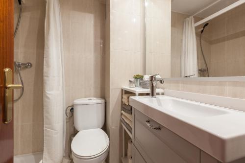 a bathroom with a toilet and a sink at Canet Platja Apartment in Canet de Mar