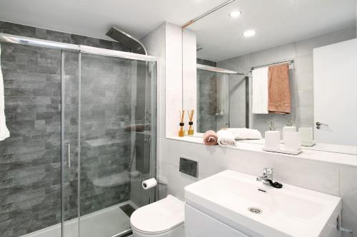 a bathroom with a shower and a toilet and a sink at Tamaran Bureba 511 in Maspalomas
