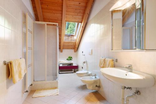 a bathroom with a sink and a toilet and a mirror at Melcherhof in Trodena