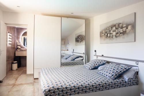 a bedroom with two beds and a mirror at Lucerta Bella in Aix-en-Provence