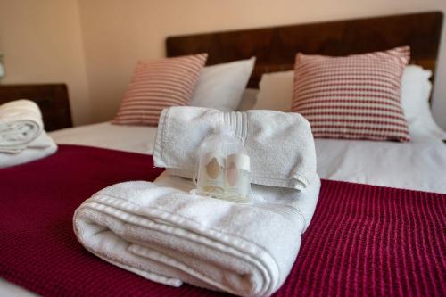 a pile of white towels on a bed at Villa Iconi Lake Garda in Manerba del Garda