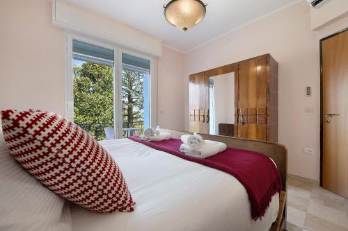 a bedroom with a large bed with two pillows at Villa Iconi Lake Garda in Manerba del Garda