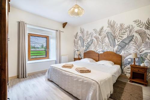 a bedroom with a large bed and a window at Gite Palombe in Lanvallay