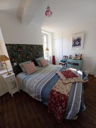 a bedroom with a large bed and a desk at Chambre Bleue - Ostau la Lutz in Saint-Germain-de-Calberte