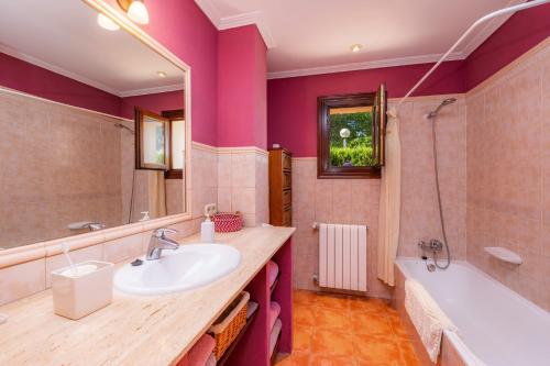 a bathroom with a sink and a tub at Na Forana in Cala Ratjada