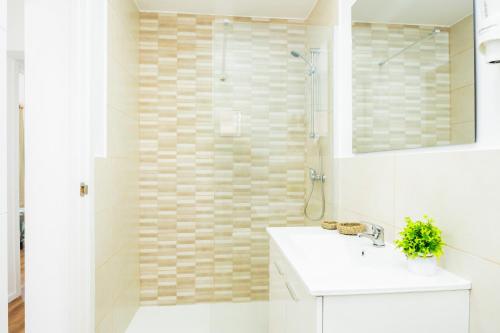 a bathroom with a white sink and a shower at Gran Sol Family 5 in Felanitx