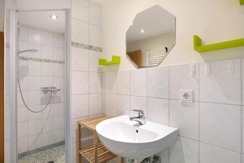 a white bathroom with a sink and a shower at Ferienwohnung Shaun in Blankenburg