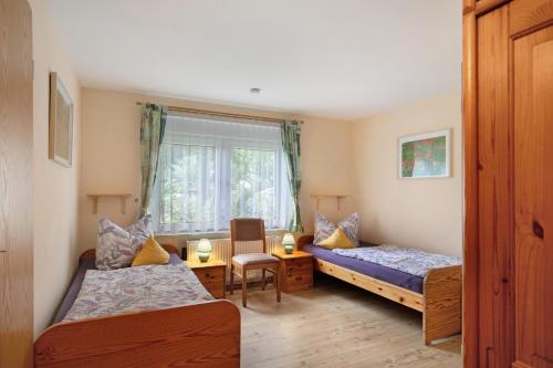 a bedroom with two beds and a window at Ferienwohnung Shaun in Blankenburg