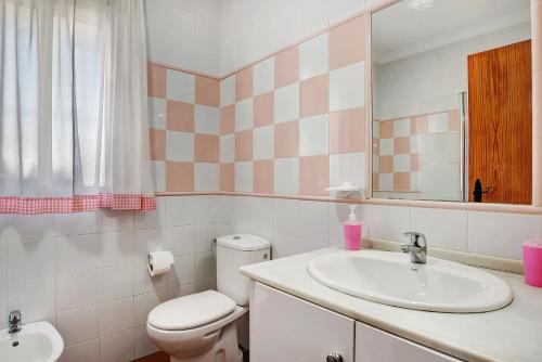 a bathroom with a toilet and a sink at Casa Antonia 2 in Conil de la Frontera
