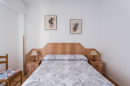 a bedroom with a bed and two pictures on the wall at Bonanza in Gandía
