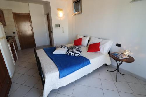 a bedroom with a large bed with colorful pillows at Casa vacanze Frida in Salento in Otranto
