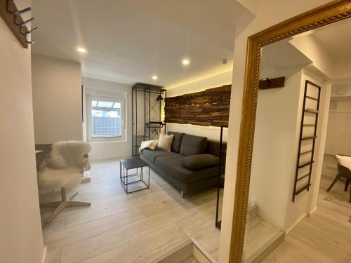 a living room with a couch and a mirror at Ferienwohnung Nele in Plettenberg