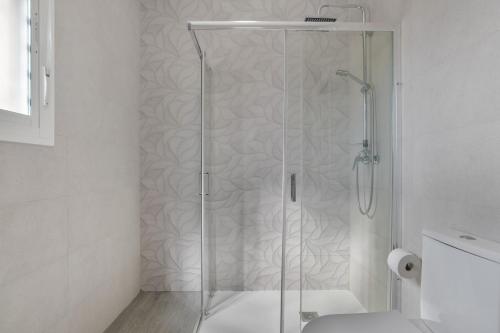 a shower with a glass door in a bathroom at El Descanso in Conil de la Frontera