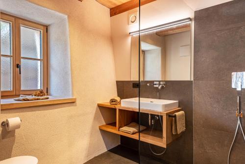 a bathroom with a sink and a shower at Egger an der Lahn - Apt Nonna in San Genesio Atesino