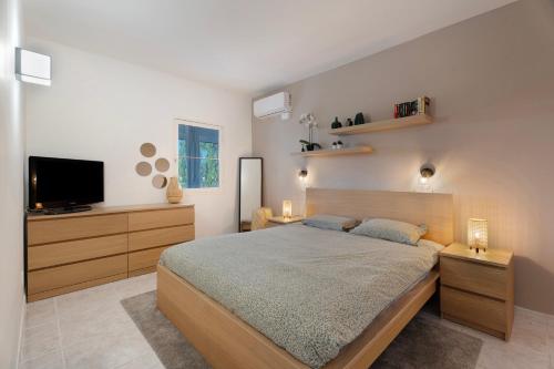 a bedroom with a bed and a flat screen tv at Casa Noa in Costa Del Silencio