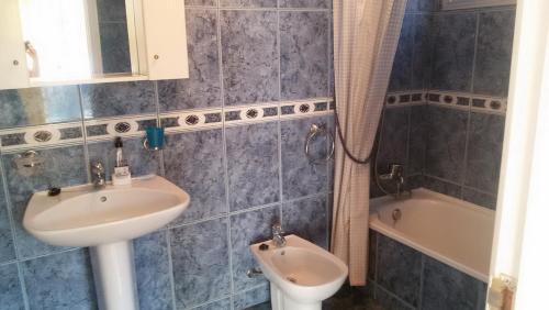 a bathroom with a sink and a toilet and a tub at Salvaje Villa with private Pool in Adeje
