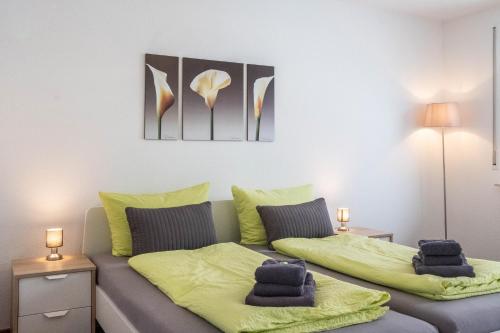 a bedroom with a bed with two pillows on it at Schwarzwaldblick F App 3 mit Pool in Schönwald