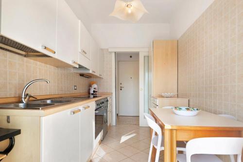 a kitchen with a sink and a table with a bowl on it at Maison Giovanna with garage parking in Rapallo