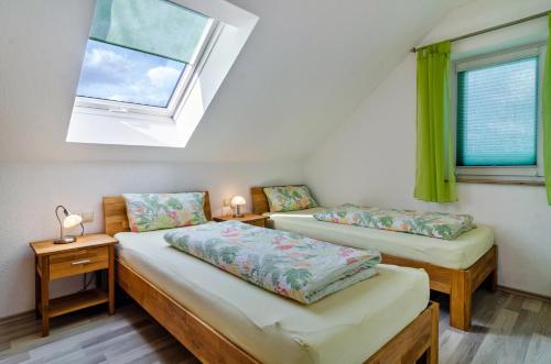 two beds in a room with a window at Arnold Laubbach in Ostrach