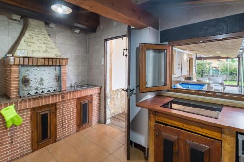 a kitchen with a sink and a stove in it at Casa Rural Alojamientos Marte in Hinojedo
