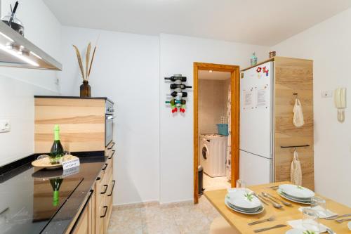 a kitchen with a wooden table and a refrigerator at Attaday Home Holidays in Ingenio